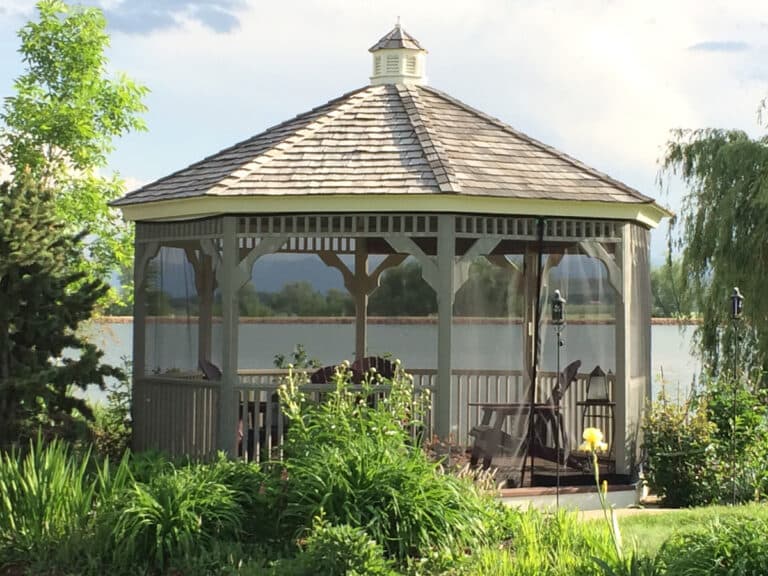 Wooden lakeside gazebo with fine mesh screen panels between the posts